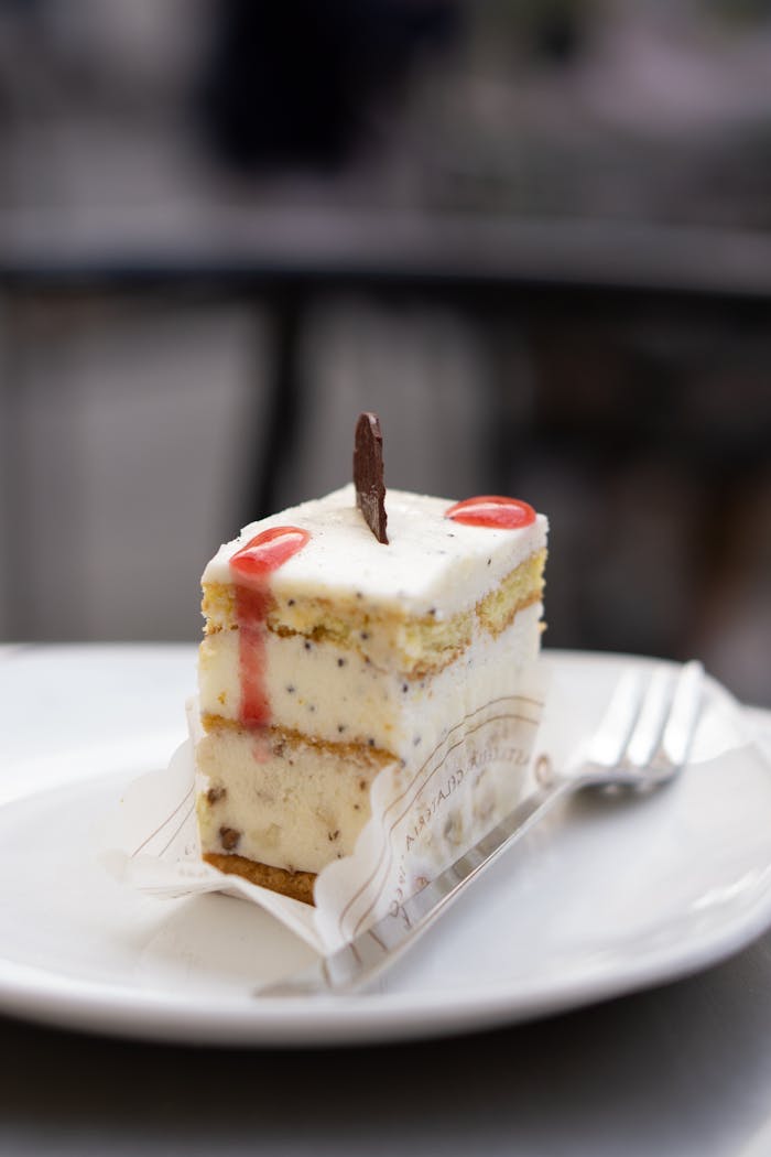 Home Indulge in a creamy layered cheesecake topped with a chocolate garnish, perfect for dessert lovers.